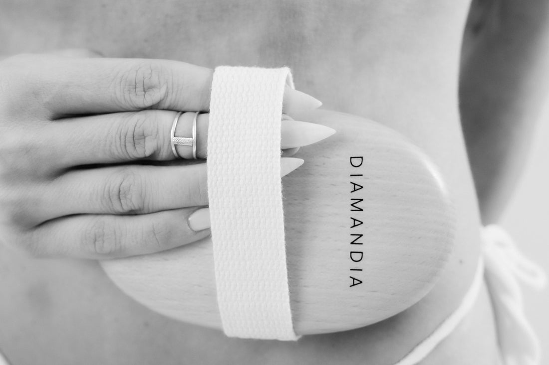 Dry brush being held by a woman's hand.