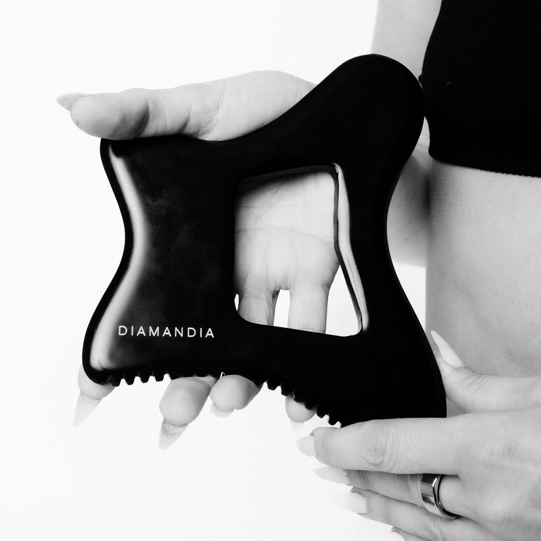 A black Gua Sha tool made from Bian stone.